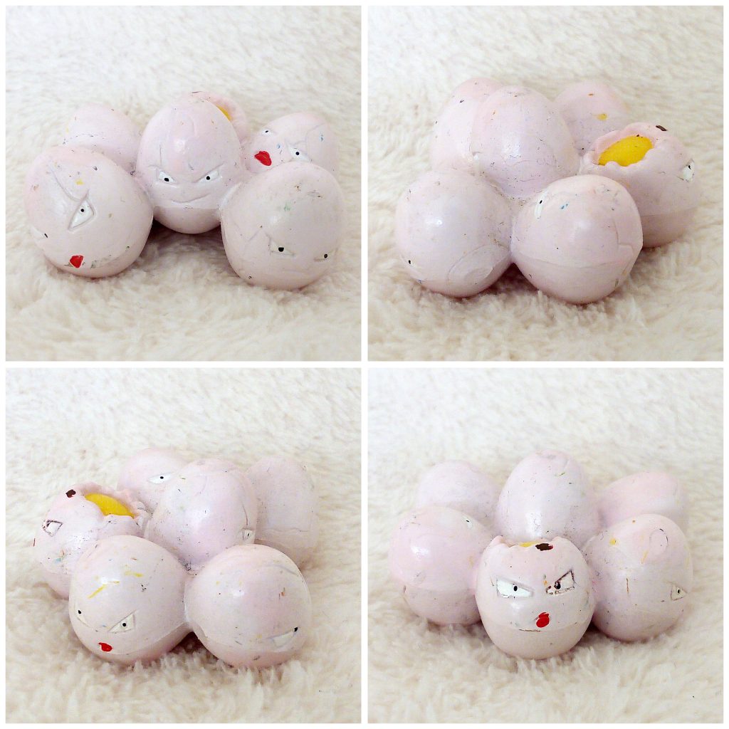 A front, left, right and back view of the Pokémon Tomy figure Exeggcute