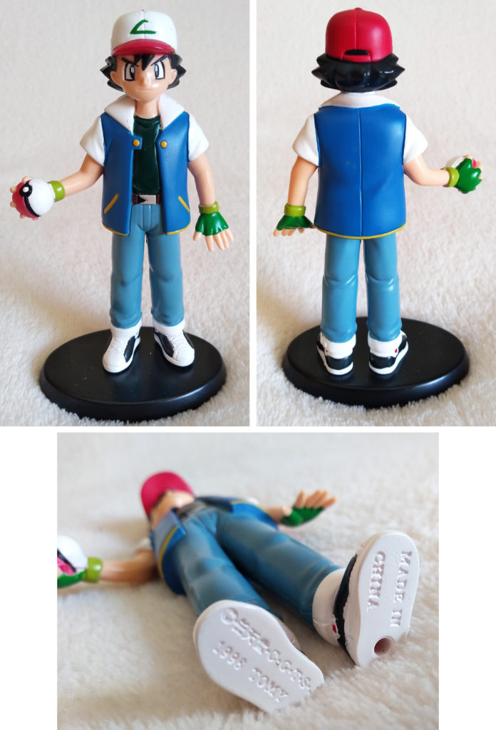 A front, back and bottom view of the Pokémon Tomy Ash figure 