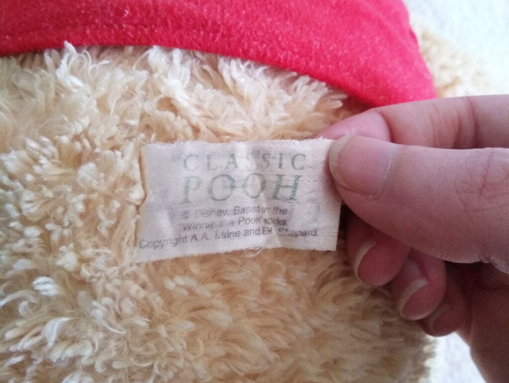 The tush tag of Winnie the Pooh, Classic Pooh plush by Golden Bear