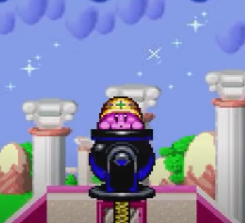Screenshot of Kirby Super Star, with Kirby sat in a cannon